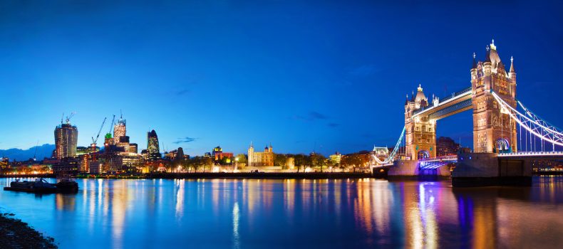 Tower Bridge and the City of London skyline at night, home of Goalhanger Podcasts
