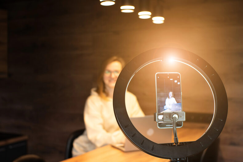 Creator live streaming from a smartphone mounted on a ring light